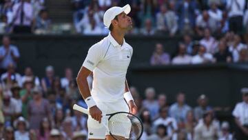 Serbia's Novak Djokovic blows a kiss to somebody in the crowd as he plays against Britain's Cameron Norrie during their men's singles semi final tennis match on the twelfth day of the 2022 Wimbledon Championships at The All England Tennis Club in Wimbledon, southwest London, on July 8, 2022. - RESTRICTED TO EDITORIAL USE (Photo by Adrian DENNIS / AFP) / RESTRICTED TO EDITORIAL USE (Photo by ADRIAN DENNIS/AFP via Getty Images)