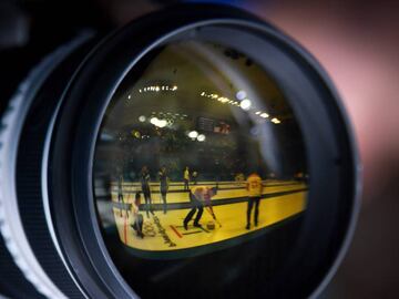 This photo rotated 180 degrees shows Switzerland&#039;s players reflected in a photographer&#039;s lens during the curling men&#039;s round robin session between Japan and Switzerland during the Pyeongchang 2018 Winter Olympic Games at the Gangneung Curling Centre in Gangneung on February 16, 2018. / AFP PHOTO / WANG Zhao
