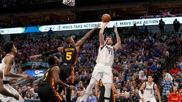 DALLAS, TEXAS - JANUARY 18: Luka Doncic #77 of the Dallas Mavericks shoots the ball against Dejounte Murray #5 of the Atlanta Hawks in the fourth quarter at American Airlines Center on January 18, 2023 in Dallas, Texas. NOTE TO USER: User expressly acknowledges and agrees that, by downloading and or using this photograph, User is consenting to the terms and conditions of the Getty Images License Agreement.   Tom Pennington/Getty Images/AFP (Photo by TOM PENNINGTON / GETTY IMAGES NORTH AMERICA / Getty Images via AFP)