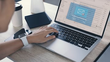 Blocking spam e-mail, warning pop-up for phishing mail, network security concept. Business woman working on laptop computer at home with warning window on screen