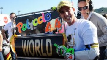 Pol Espargaró, sostiene orgulloso un cartel que proclama la consecución del campeonato mundial de Moto2