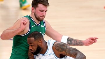 Dec 25, 2020; Los Angeles, California, USA;  Dallas Mavericks guard Luka Doncic (77) guards Los Angeles Lakers forward LeBron James (23) as he drives to the basket in the first half of the game at Staples Center. Mandatory Credit: Jayne Kamin-Oncea-USA TODAY Sports