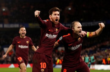 Lionel Messi celebrates with Andres Iniesta after scoring their first goal.