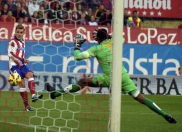 El delantero francés del Atlético de Madrid Antoine Griezmann supera al portero camerunés del Málaga Carlos Kameni para marcar el segundo gol de su equipo.