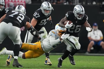 Las Vegas Raiders running back Josh Jacobs (28) carries the ball against Los Angeles Chargers safety Derwin James Jr. 