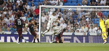 Karim Benzema (centre) heads Real Madrid into a second-minute lead.