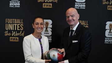 This handout picture released by the Mexican Presidency shows Mexico's President Claudia Sheinbaum (L) and FIFA President Gianni Infantino (R) posing for a photo with a ball during the draw for the 2026 FIFA Football World Cup taking place in the US, Canada and Mexico, at the Kennedy Center, in Washington, DC, on December 5, 2025. (Photo by Handout / Mexican Presidency / AFP) / RESTRICTED TO EDITORIAL USE - MANDATORY CREDIT "AFP PHOTO / MEXICAN PRESIDENCY" - HANDOUT - NO MARKETING NO ADVERTISING CAMPAIGNS - DISTRIBUTED AS A SERVICE TO CLIENTS