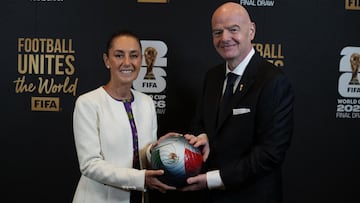 This handout picture released by the Mexican Presidency shows Mexico's President Claudia Sheinbaum (L) and FIFA President Gianni Infantino (R) posing for a photo with a ball during the draw for the 2026 FIFA Football World Cup taking place in the US, Canada and Mexico, at the Kennedy Center, in Washington, DC, on December 5, 2025. (Photo by Handout / Mexican Presidency / AFP) / RESTRICTED TO EDITORIAL USE - MANDATORY CREDIT "AFP PHOTO / MEXICAN PRESIDENCY" - HANDOUT - NO MARKETING NO ADVERTISING CAMPAIGNS - DISTRIBUTED AS A SERVICE TO CLIENTS