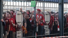 (FILES) In this file photo taken on May 28, 2022 Liverpool fans stand outside unable to get in in time leading to the match being delayed prior to the UEFA Champions League final football match between Liverpool and Real Madrid at the Stade de France in Saint-Denis, north of Paris. - UEFA will reimburse all Liverpool supporters who attended last year's chaos-hit Champions League final between the English club and Real Madrid at the Stade de France in Paris, European football's governing body said on March 7, 2022. (Photo by Thomas COEX / AFP)