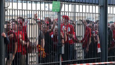 (FILES) In this file photo taken on May 28, 2022 Liverpool fans stand outside unable to get in in time leading to the match being delayed prior to the UEFA Champions League final football match between Liverpool and Real Madrid at the Stade de France in Saint-Denis, north of Paris. - UEFA will reimburse all Liverpool supporters who attended last year's chaos-hit Champions League final between the English club and Real Madrid at the Stade de France in Paris, European football's governing body said on March 7, 2022. (Photo by Thomas COEX / AFP)