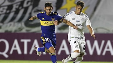 Alan Varela of Argentina's Boca Juniors, left, and Kayo Jorge of Brazil's Santos battle for the ball during a Copa Libertadores soccer match in Santos, Brazil, Tuesday, May 11, 2021. (Guilherme Dionizio/Pool via AP)