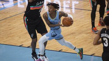 Dec 23, 2020; Memphis, Tennessee, USA; Memphis Grizzlies guard Ja Morant (12) goes to the basket against San Antonio Spurs forward LaMarcus Aldridge (12) during the first half at FedExForum. Mandatory Credit: Justin Ford-USA TODAY Sports