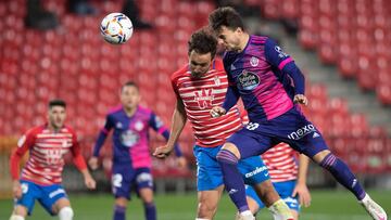 Real Valladolid's Spanish midfielder Oscar Plano (R) scores a goal past Granada's Spanish defender German Sanchez during the Spanish League football match between Granada FC and Real Valladolid FC at the Nuevo Los Carmenes stadium in Granada on