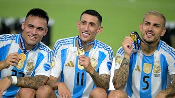 Argentina's forward #22 Lautaro Martinez, Argentina's forward #11 Angel Di Maria and Argentina's forward #05 Leandro Paredes pose with their medals following their team's victory in the Conmebol 2024 Copa America tournament final football match between Argentina and Colombia at the Hard Rock Stadium, in Miami, Florida on July 14, 2024. (Photo by JUAN MABROMATA / AFP)
