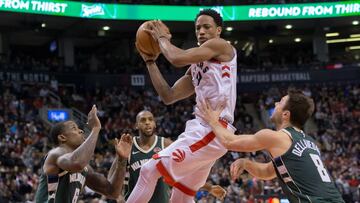 Jan 1, 2018; Toronto, Ontario, CAN; Toronto Raptors guard DeMar DeRozan (10) shoots the ball as Milwaukee Bucks guard Matthew Dellavedova (8) and guard Eric Bledsoe (6) defend during the second half at Air Canada Centre. Mandatory Credit: Kevin Sousa-USA TODAY Sports