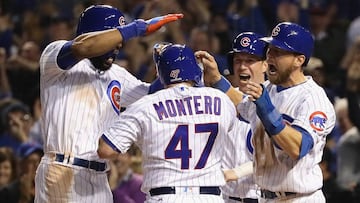 CHICAGO, IL - OCTOBER 15: Miguel Montero #47 of the Chicago Cubs celebrates with Jason Heyward #22, Chris Coghlan #8 and Ben Zobrist #18 after hitting a grand slam home run in the eighth inning against the Los Angeles Dodgers during game one of the National League Championship Series at Wrigley Field on October 15, 2016 in Chicago, Illinois.   Jonathan Daniel/Getty Images/AFP
 == FOR NEWSPAPERS, INTERNET, TELCOS &amp; TELEVISION USE ONLY ==