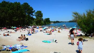 People gather on a sunny afternoon on the beach of the Lake of Bordeaux, south-western France, on June 13, 2021. (Photo by MEHDI FEDOUACH / AFP)