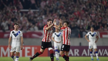 Estudiantes de la Plata's Uruguayan Agustin Rogel celebrates with Estudiantes de la Plata's Leandro Diaz (L) after scoring against Velez Sarsfield during the all-Argentina Copa Libertadores group stage first leg football at the Jorge Luis Hirschi stadium, in La Plata, Buenos Aires province, Argentina, on April 7, 2022. (Photo by Juan Mabromata / AFP)