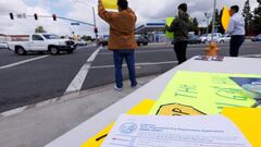 Republican activists seek drivers&#039; attention as they work to register voters to their party at a gas station in Garden Grove, California.