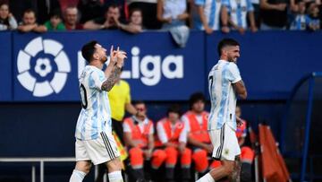 Argentina's forward Lionel Messi (L) celebrates after scoring his team's third goal during the international friendly football match between Argentina and Estonia at El Sadar stadium in Pamplona on June 5, 2022. (Photo by ANDER GILLENEA / AFP) (Photo by ANDER GILLENEA/AFP via Getty Images)