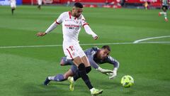 SEVILLE, SPAIN - MARCH 14: Yousseff En-Nesyri of Sevilla scores their side's first goal as he is challenged by Joel Robles of Real Betis during the La Liga Santander match between Sevilla FC and Real Betis at Estadio Ramon Sanchez Pizjuan on March 14, 202