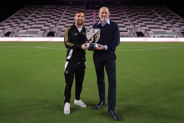 Inter Miami CF forward Lionel Messi (10) and MLS commissioner Don Garber hold the London Donovan MVP Award