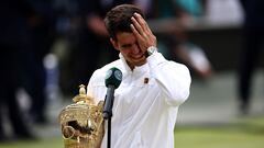 Spain's Carlos Alcaraz holds the winner's trophy as he delivers a speech following his victory against Serbia's Novak Djokovic during their men's singles final tennis match on the fourteenth day of the 2024 Wimbledon Championships at The All England Lawn Tennis and Croquet Club in Wimbledon, southwest London, on July 14, 2024. Defending champion Alcaraz beat seven-time winner Novak Djokovic in a blockbuster final, with Alcaraz winning 6-2, 6-2, 7-6. (Photo by HENRY NICHOLLS / AFP) / RESTRICTED TO EDITORIAL USE