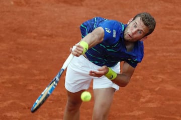 France's Mathias Bourgue serves