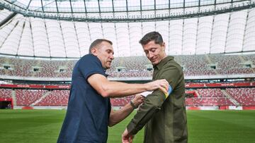 WARSAW, POLAND - SEPTEMBER 20: Poland captain Robert Lewandowski receives a Ukraine armband from Laureus Ambassador Andriy Shevchenko and pledges to carry it to FIFA World Cup 2022 Qatar at PGE Narodowy Stadium on September 20, 2022 in Warsaw, Poland. (Photo by Joosep Martinson/Getty Images for Laureus)