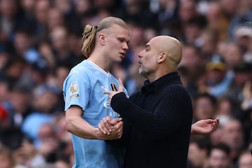 Manchester City's Spanish manager Pep Guardiola (R) speaks with Manchester City's Norwegian striker #09 Erling Haaland (L) as he leaves the pitch after being substituted during the English Premier League football match between Manchester City and Wolverhampton Wanderers at the Etihad Stadium in Manchester, north west England, on May 4, 2024. (Photo by Darren Staples / AFP) / RESTRICTED TO EDITORIAL USE. No use with unauthorized audio, video, data, fixture lists, club/league logos or 'live' services. Online in-match use limited to 120 images. An additional 40 images may be used in extra time. No video emulation. Social media in-match use limited to 120 images. An additional 40 images may be used in extra time. No use in betting publications, games or single club/league/player publications. / 