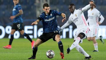 BERGAMO, ITALY - FEBRUARY 24: Marten De Roon of Atalanta B.C. is tackled by Ferland Mendy of Real Madrid during the UEFA Champions League Round of 16 match between Atalanta and Real Madrid at Gewiss Stadium on February 24, 2021 in Bergamo, Italy. Sporting