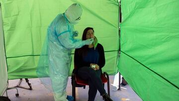 A woman undergoes a PCR test for the novel coronavirus at a control post in the municipality of Renca, Santiago on August 26, 2020. - After critical weeks in May and June, Chile managed to keep the new cases of coronavirus stable in most of the country. T