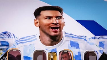 Members of the Argentinian team peer out from the windows on their plane adorned with a picture of Argentina's forward Lionel Messi and teammates as the team arrives at the Hamad International Airport in Doha on November 17, 2022, ahead of the Qatar 2022 World Cup football tournament. (Photo by Odd ANDERSEN / AFP) (Photo by ODD ANDERSEN/AFP via Getty Images)