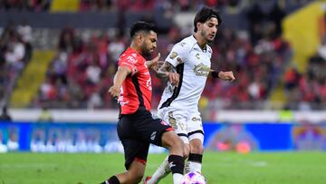 Eduardo Aguirre (L) of Atlas fights for the ball with Jesus Gomez (R) of Tijuana during the 14th round match between Atlas and Tijuana as part of the Liga BBVA MX, Torneo Apertura 2024 at Jalisco Stadium on October 26, 2024 in Guadalajara, Jalisco, Mexico.