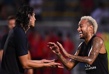 Paris Saint-Germain's Brazilian forward Neymar (R) shares a light moment with teammate Paris Saint-Germain's Uruguayan forward Edinson Cavani  as they take part in a training session in Shenzhen on August 1, 2019, ahead of the French Trophy of Champions f