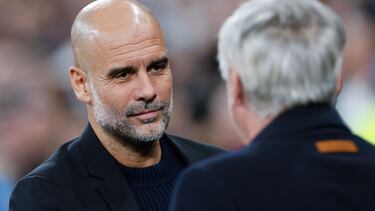 Manchester City's Spanish coach Pep Guardiola (L) greets Real Madrid's Italian coach Carlo Ancelotti during the UEFA Champions League knockout phase play-off football match between Real Madrid CF and Manchester City at the Santiago Bernabeu stadium in Madrid on February 19, 2025. (Photo by OSCAR DEL POZO / AFP)