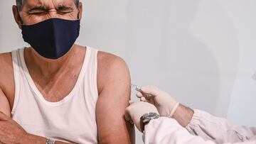 CATANIA, ITALY - NOVEMBER 20: A man sits in his doctor&#039;s surgery while he is being given the flu vaccine on November 20, 2020 in Catania, Italy. As the COVID-19 pandemic is still active, vaccination against influenza viruses circulating in the 2020/2