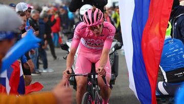 Pink jersey Team UAE's Slovenian rider Tadej Pogacar climbs surrounded by fans to win the 15th stage of the 107th Giro d'Italia cycling race, 222km between Manerba del Garda and Mottolino on May 19, 2024. (Photo by Luca Bettini / POOL / AFP)