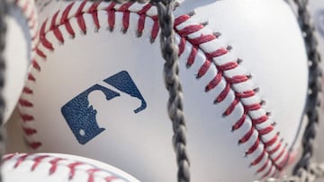 (FILES) In this file photo taken on June 27, 2018 a baseball with MLB logo is seen at Citizens Bank Park before a game between the Washington Nationals and Philadelphia Phillies in Philadelphia, Pennsylvania. - Nine players and four staffers tested positi