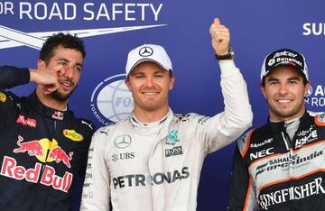 Mercedes' Nico Rosberg (centre) celebrates next to second-placed Force India driver Sergio Pérez (right) and Red Bull Racing's Daniel Ricciardo, who took third.