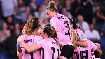 Scotland's defender Jennifer Beattie (hidden) is congratulated by teammates after scoring a goal during the France 2019 Women's World Cup Group D football match between Scotland and Argentina, on June 19, 2019, at the Parc des Princes stadium in