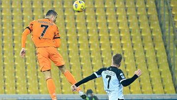Juventus' Portuguese forward Cristiano Ronaldo jumps to score a header during the Italian Serie A football match Parma vs Juventus on December 19, 2020 at the Ennio-Tardini stadium in Parma. (Photo by Alberto PIZZOLI / AFP)