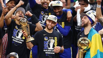 Stephen Curry #30 and Klay Thompson #11 of the Golden State Warriors celebrate with the Bill Russell NBA Finals Most Valuable Player Award and the Larry O'Brien Championship Trophy