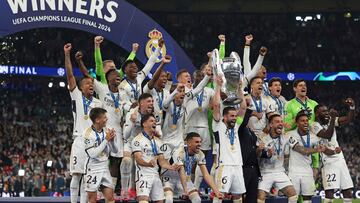 Real Madrid's Spanish defender #06 Nacho Fernandez lifts the trophy to celebrate their victory at the end of the UEFA Champions League final football match between Borussia Dortmund and Real Madrid, at Wembley stadium, in London, on June 1, 2024. Real Madrid wins the Champions League final 2 - 0 against Borussia Dortmund. (Photo by Adrian DENNIS / AFP)