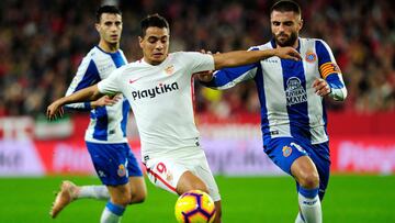 Sevilla's French forward Wissam Ben Yedder (C) vies with Espanyol's Spanish midfielder David Lopez (R) during the Spanish league football match between Sevilla FC and RCD Espanyol at the Ramon Sanchez Pizjuan stadium in Seville on November 11, 2