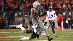 COLUMBUS, OHIO - NOVEMBER 11: Marvin Harrison Jr. #18 of the Ohio State Buckeyes breaks away from a tackle by Ade Willie #20 of the Michigan State Spartans during the third quarter of a game at Ohio Stadium on November 11, 2023 in Columbus, Ohio.   Ben Jackson/Getty Images/AFP (Photo by Ben Jackson / GETTY IMAGES NORTH AMERICA / Getty Images via AFP)