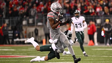 COLUMBUS, OHIO - NOVEMBER 11: Marvin Harrison Jr. #18 of the Ohio State Buckeyes breaks away from a tackle by Ade Willie #20 of the Michigan State Spartans during the third quarter of a game at Ohio Stadium on November 11, 2023 in Columbus, Ohio.   Ben Jackson/Getty Images/AFP (Photo by Ben Jackson / GETTY IMAGES NORTH AMERICA / Getty Images via AFP)