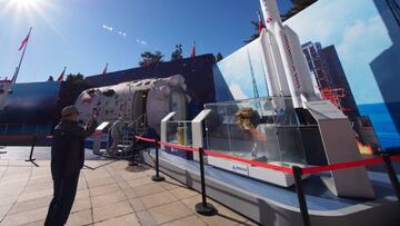 Visitors view a model of the Long March 5 rocket during the Achievement exhibition themed "Striving for a New Era" at the Beijing Exhibition Center in Beijing, China, Nov 4, 2022.