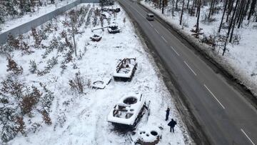 BUCHA, UKRAINE - DECEMBER 05: A man views destroyed Russian tanks outside Bucha on December 05, 2022 in Bucha, Ukraine. Ukrainian officials expect a new wave of Russian bombing this week, with previous rounds targeting critical infrastructure and causing massive water and power cuts, including in the capital Kyiv. (Photo by Jeff J Mitchell/Getty Images)