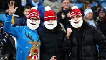 MANCHESTER, ENGLAND - DECEMBER 21: Fans in Christmas hats pose for a photo prior to the Premier League match between Manchester City and Leicester City at Etihad Stadium on December 21, 2019 in Manchester, United Kingdom. (Photo by Clive Brunskill/Getty I